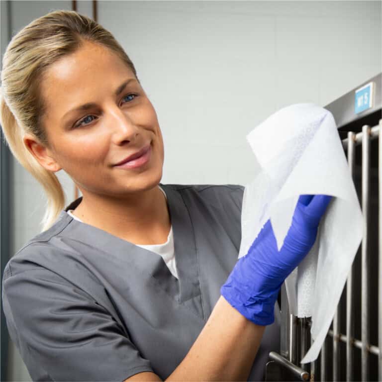 lady cleaning surfaces with disinfectant wipe