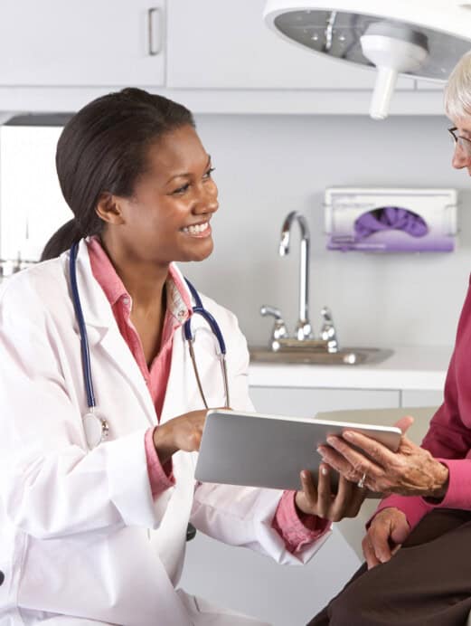 Doctor Discussing Records With Senior Female Patient