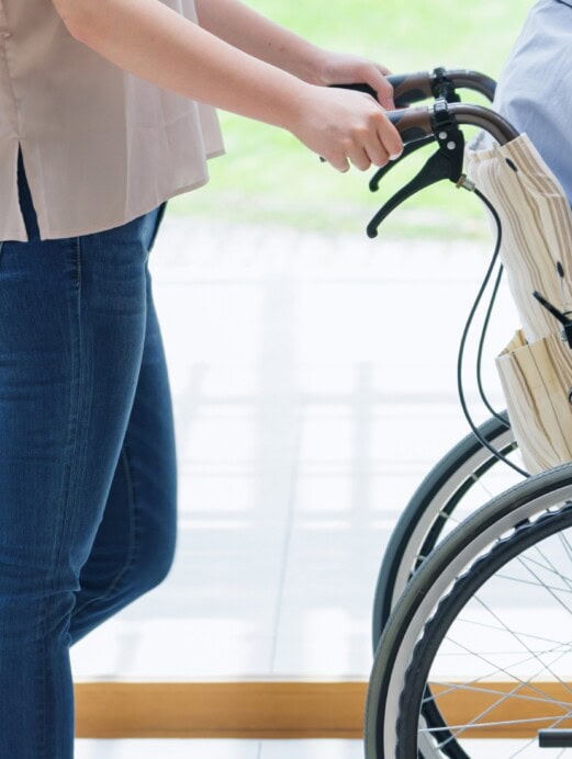 woman pushing a man in a wheelchair