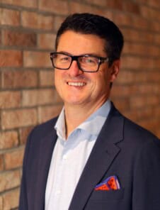 Male Headshot on brick wall