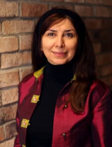 Women Headshot on brick wall